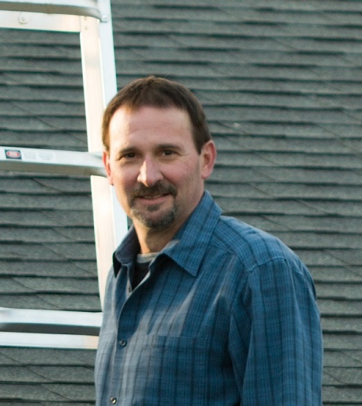 licensed home inspector on ladder inspecting gutters and drip edge-integral parts of a roof system on a home inspection near evansville indiana