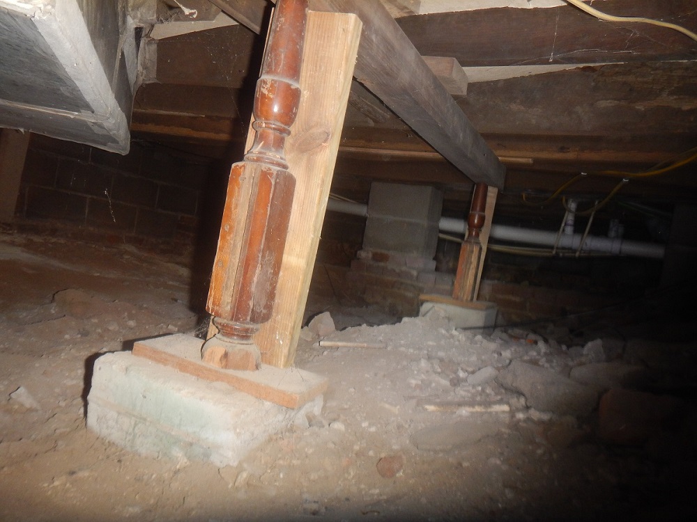 Failing floor structure being propped up by bed posts found by a home inspector near Newburgh IN            