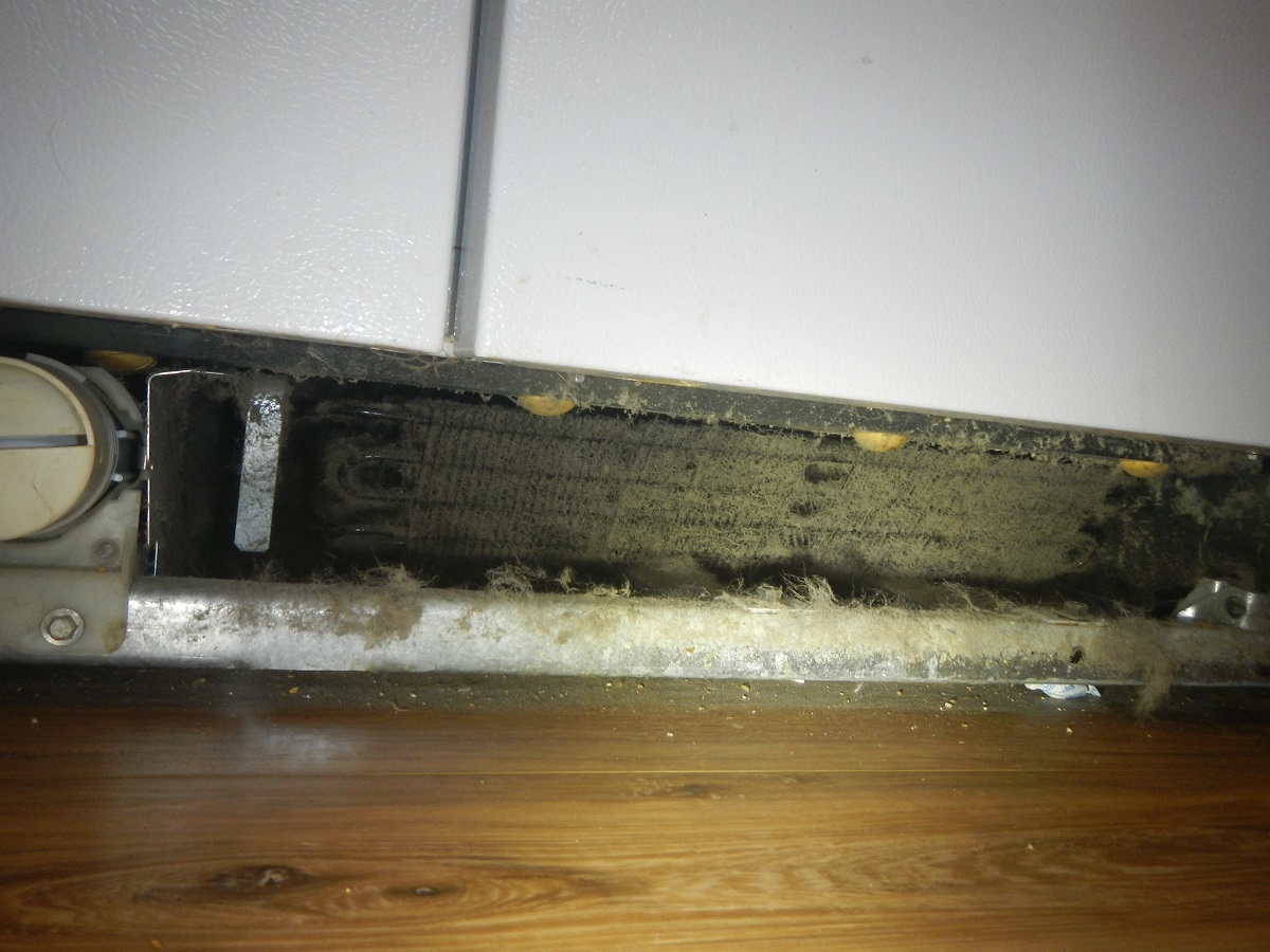 Dirty refrigerator coils found by the handyman while doing home maintenance